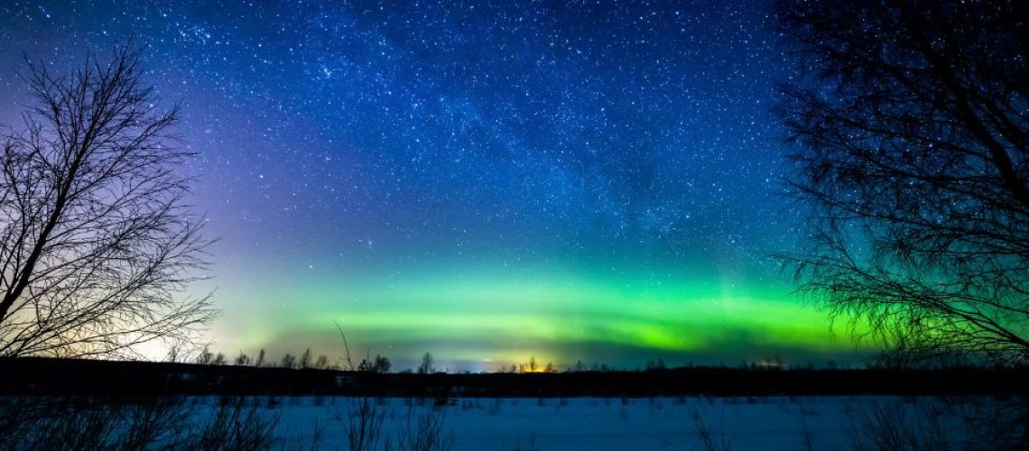 Northern lights illuminating snowy landscape